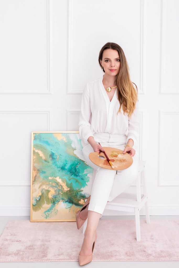Young female painter posing with her artwork at Budapest